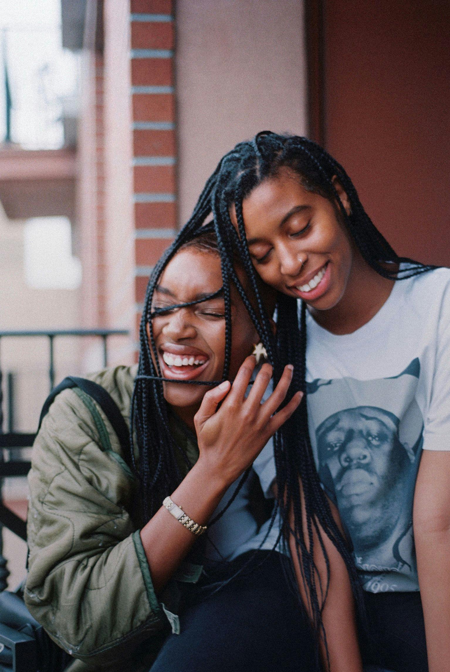 Girls with braids laughing together